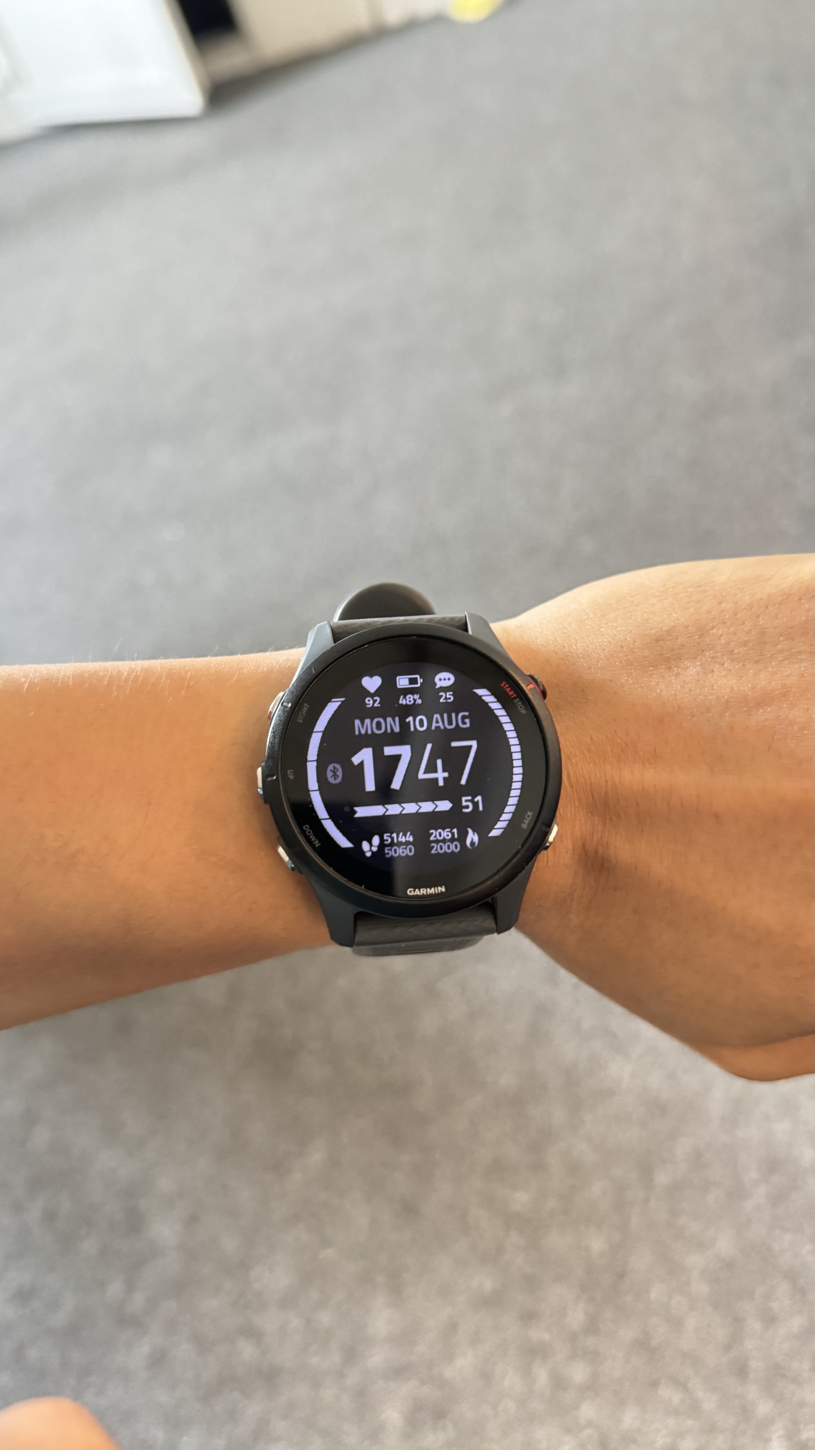 Garmin Forerunner 255 watch face showing daily steps and activity