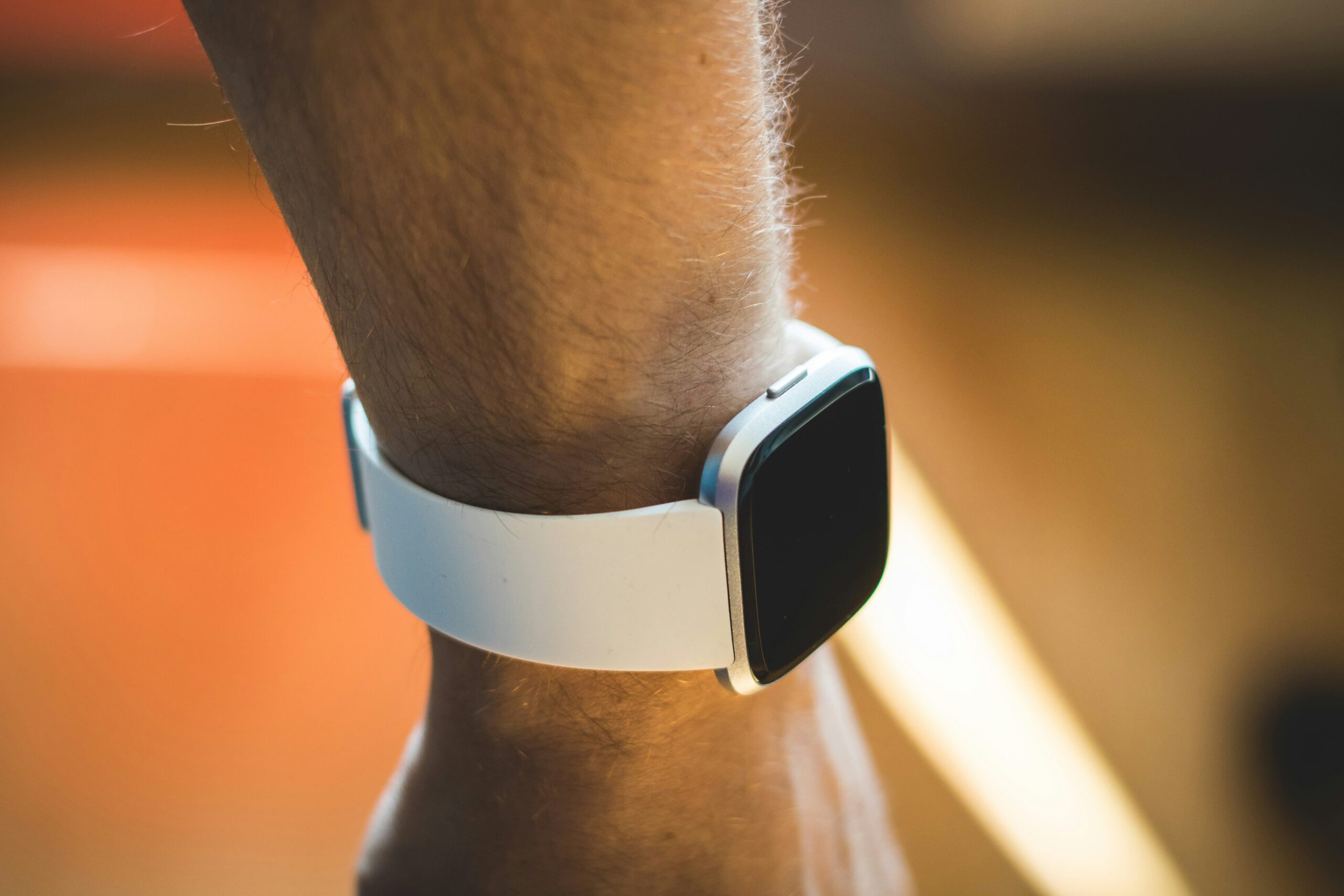 Fitbit Charge 6 fitness band on a wrist showing the display