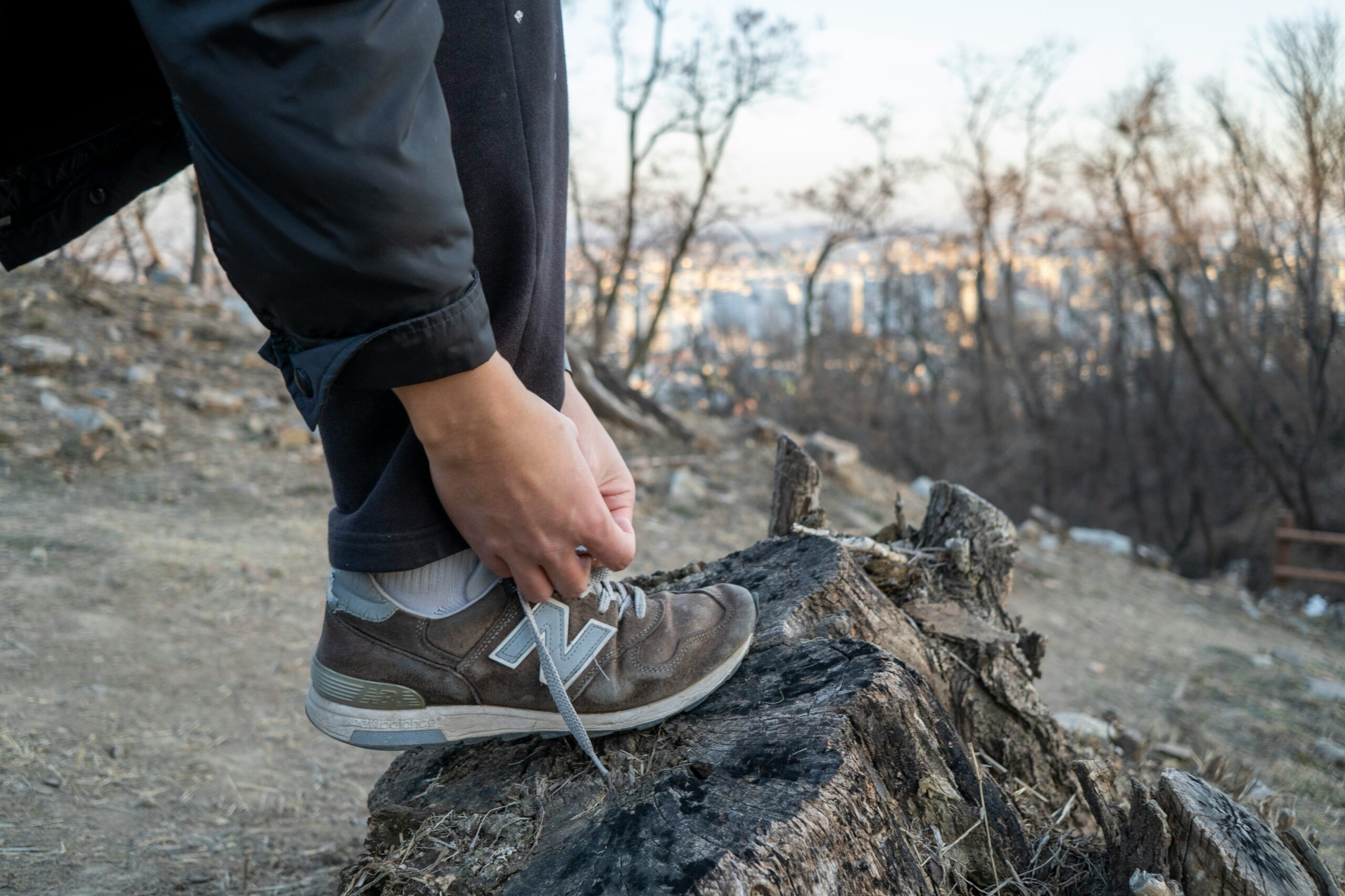 Person lacing up trainers before a walk outdoors