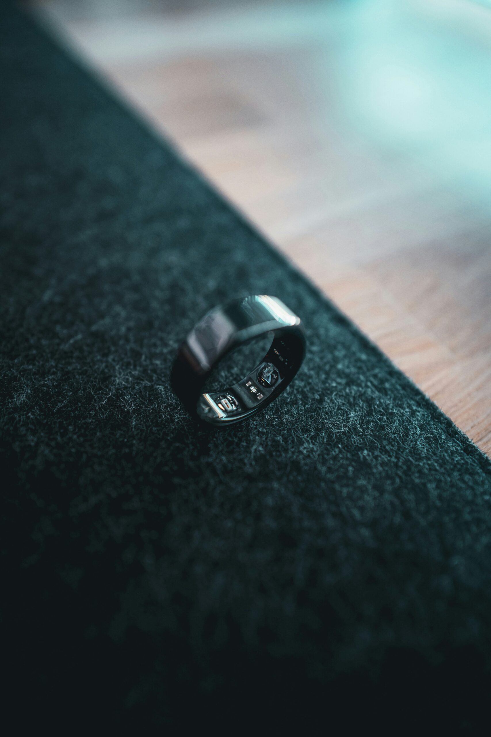 Oura Ring 4 smart ring resting on a sofa armrest