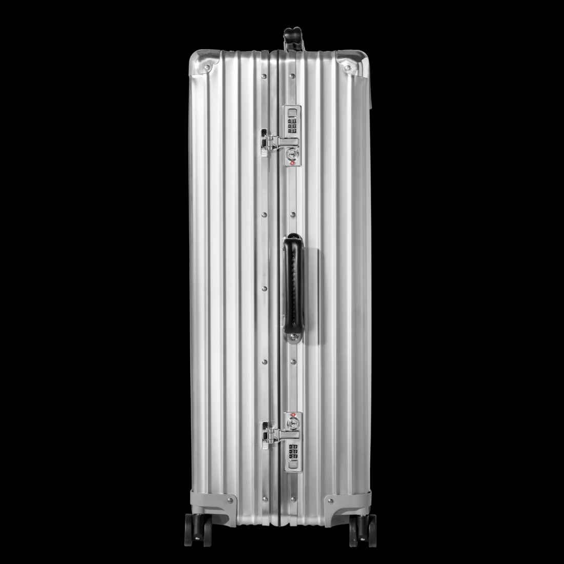 Side view of the silver RIMOWA Classic Check-In L, showing the twin TSA combination locks, side carry handle and spinner wheels
